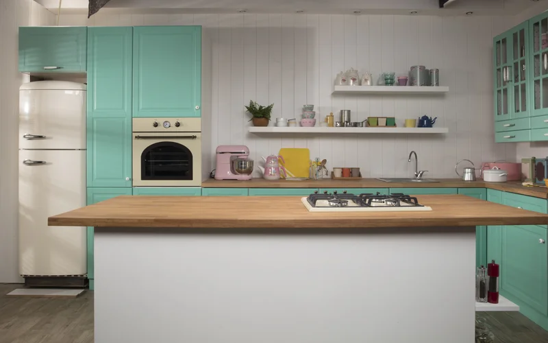 Vintage beige refrigerator in a kitchen with teal cabinets Vintage beige refrigerator in a kitchen with teal cabinets