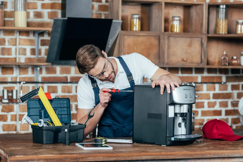 Technician repairing espresso machine on workbench with tools
