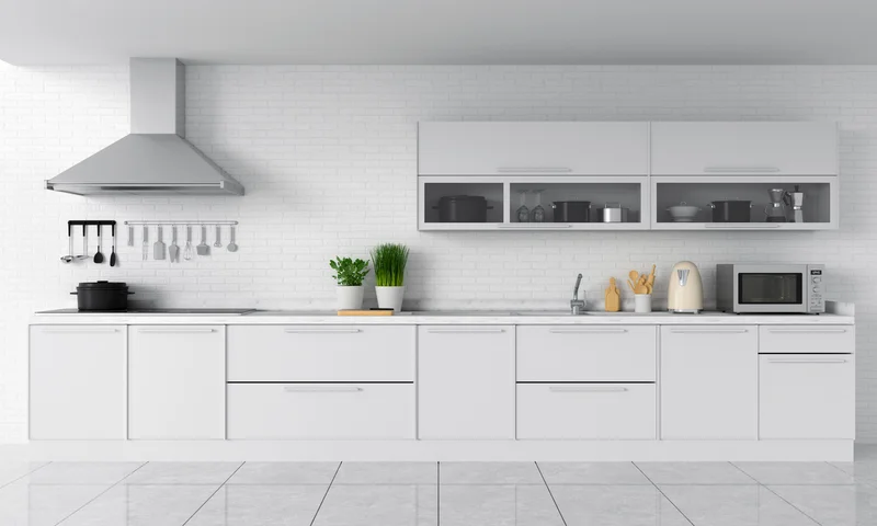 Sleek modern white kitchen cabinets with countertop microwave and range hood Sleek modern white kitchen cabinets with countertop microwave and range hood