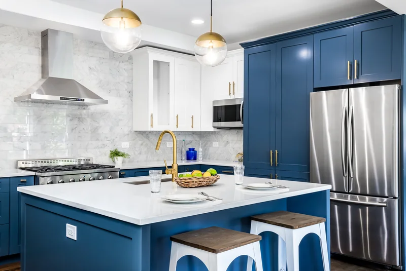 Modern blue kitchen cabinets with gold faucet and stainless steel refrigerator. Modern blue kitchen cabinets with gold faucet and stainless steel refrigerator.