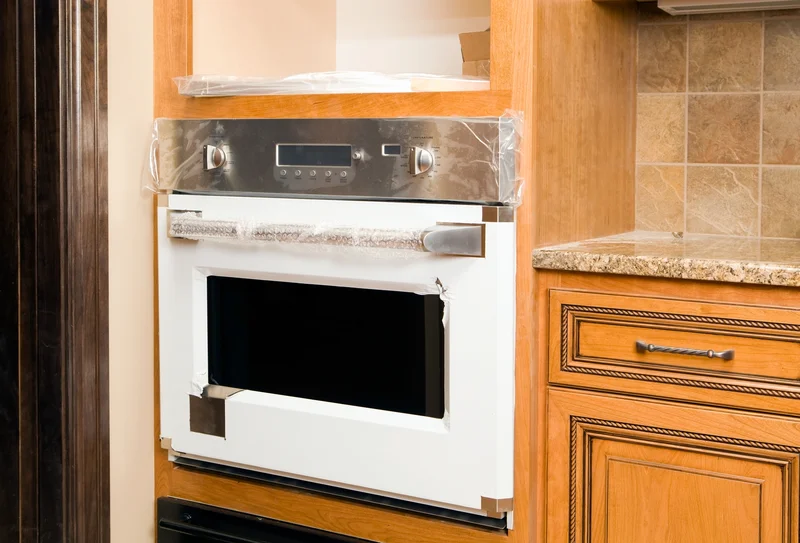 Newly installed built-in stainless steel wall oven in a modern kitchen.